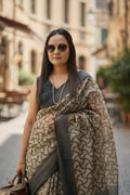 Woman in elegant printed saree and sunglasses outdoors, showcasing ethnic fashion